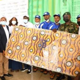 Dr. Ikechukwu Adinde, Director, Public Affairs, Nigerian Communications Commission (NCC) (2nd from left) in a symbolic presentation of the 100 mattresses to the NYSC officials and corps members during the programme.